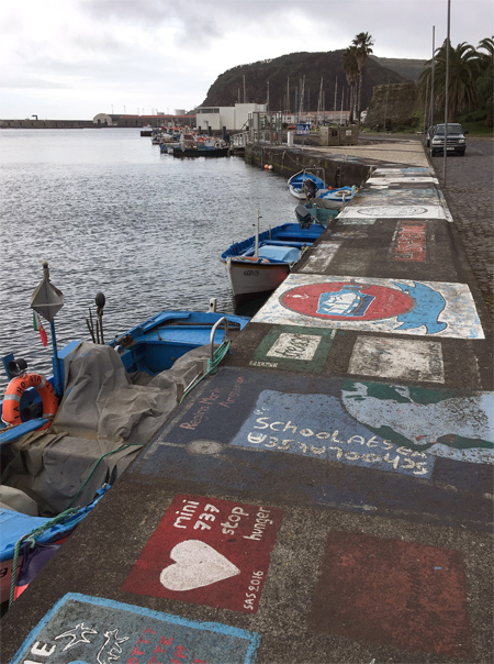 Schilderingen van zeezeilers in de haven van Horta